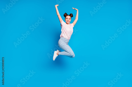 Fototapeta Naklejka Na Ścianę i Meble -  Full length body size view of her she nice attractive pretty charming cheerful cheery girl jumping having fun rejoicing rising hands up isolated on bright vivid shine vibrant blue color background