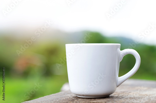 A cup of coffee is placed on the table with Natural Green.Morning Coffee