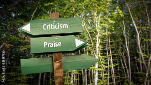 Fototapeta Naklejka Na Ścianę i Meble -  Street Sign Praise versus Criticism
