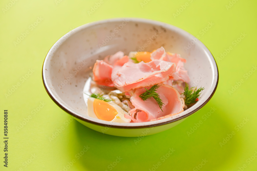 Boiled eggs with smoked ham and vegetables. Healthy vegetarian diet. Veggies salad. Boiled eggs with smoked ham and vegetables. Healthy vegetarian diet. Veggies salad.
