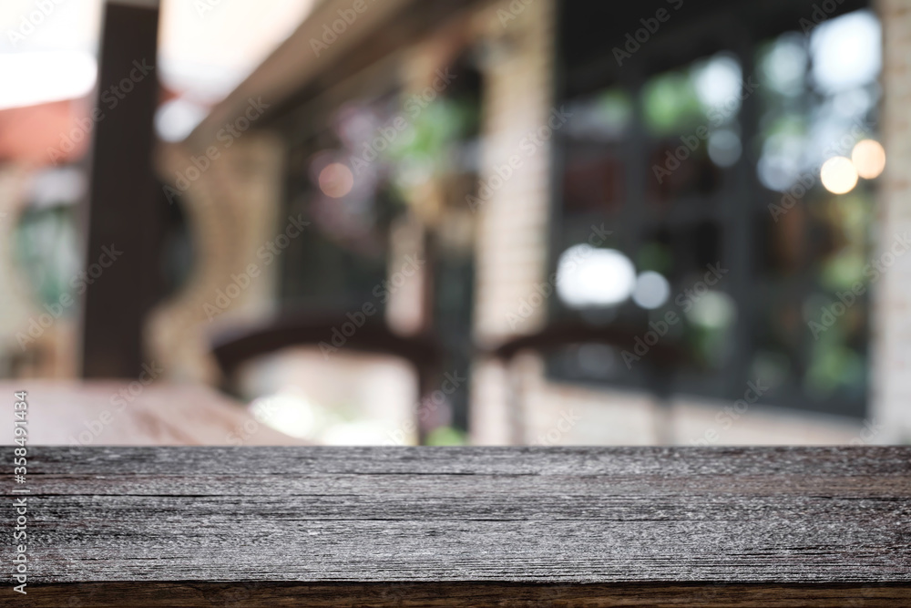Blurred background of home garden picnic and wooden table free space for product display.