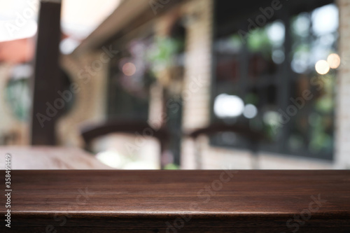 Blurred background of home garden picnic and wooden table free space for product display.