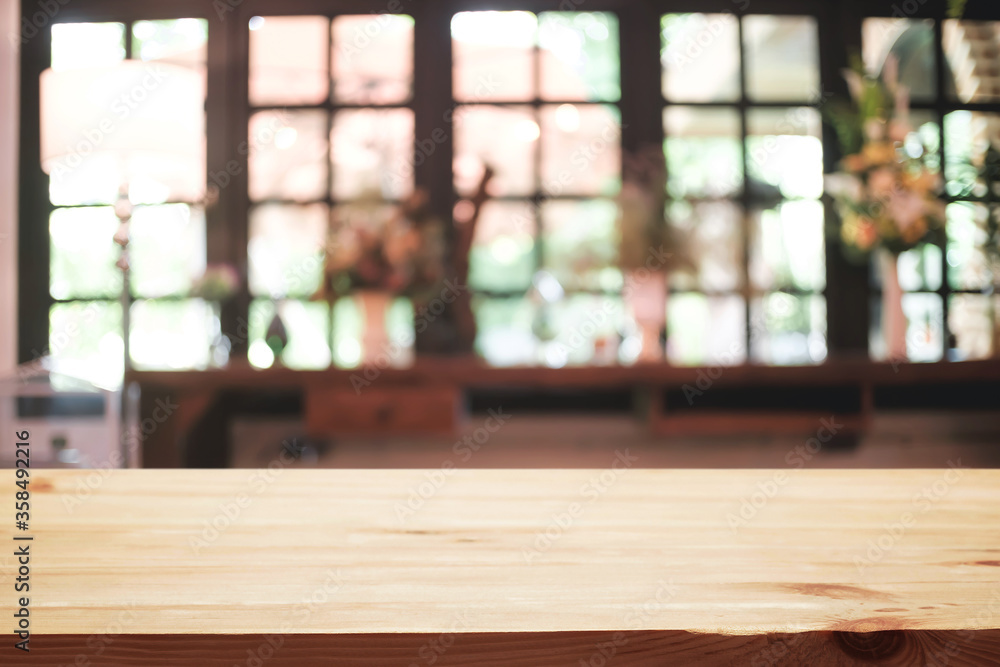 Empty wooden desk space platform and blurred restaurant or coffee shop background for product display montage.