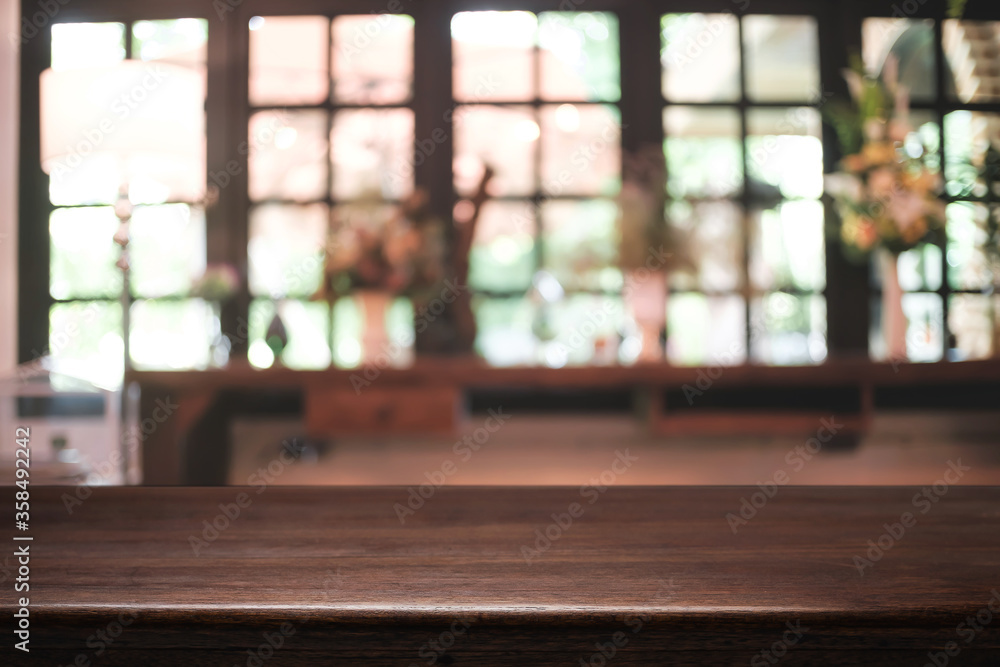 Empty wooden desk space platform and blurred restaurant or coffee shop background for product display montage. Empty wooden desk space platform and blurred restaurant or coffee shop background for product display montage.
