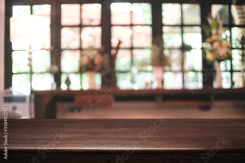 Empty wooden desk space platform and blurred restaurant or coffee shop background for product display montage.