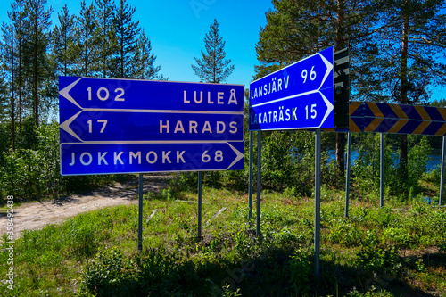 Jokkmokk, Sweden The Lule river on a sunny day, and road signs.