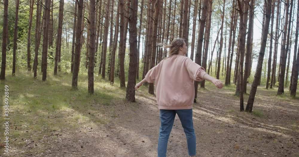 Young attractive woman walking smiling having fun in a summer forest Young attractive woman walking smiling having fun in a summer forest