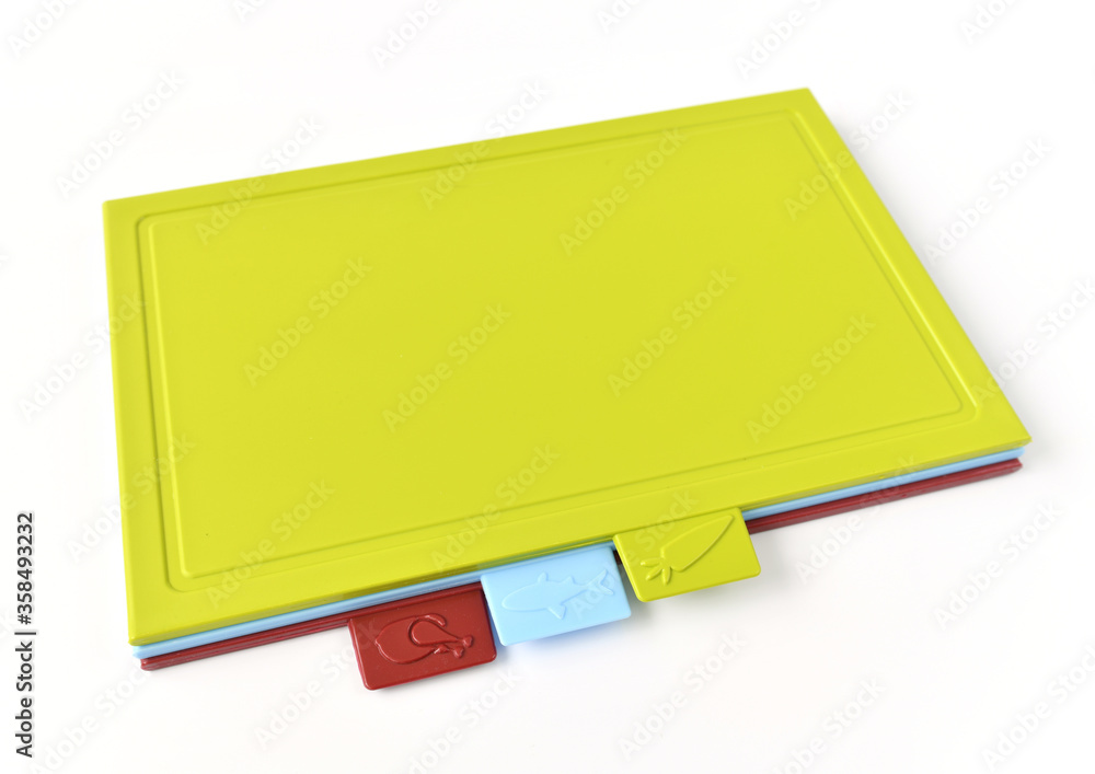 Colored plastic cutting boards on a light background Colored plastic cutting boards on a light background