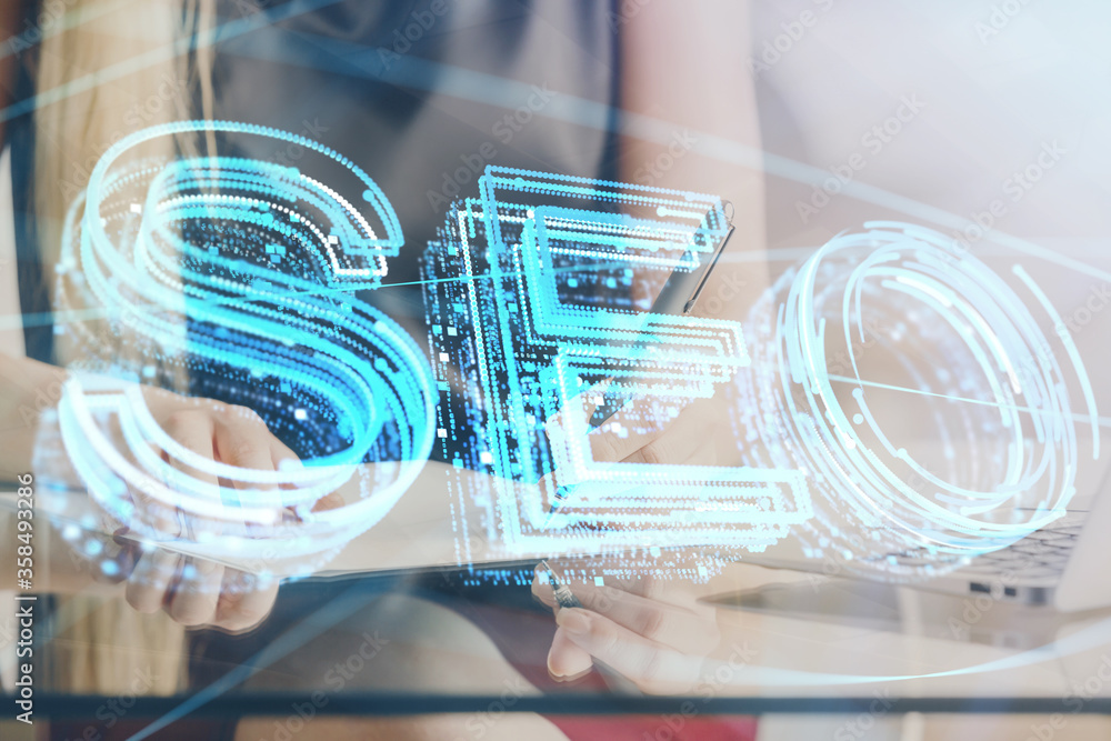 Double exposure of woman's hands making notes with SEO icon. Concept of Search engine optimization Double exposure of woman's hands making notes with SEO icon. Concept of Search engine optimization