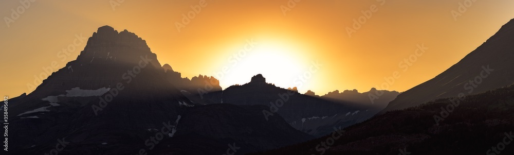 Dramatic mountain peaks silhouetted at sunset in Glacier National Park, Montana