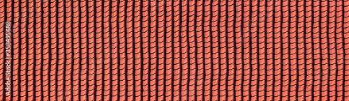 Panorama of a red tiled roof texture. pattern of antique roof tile.