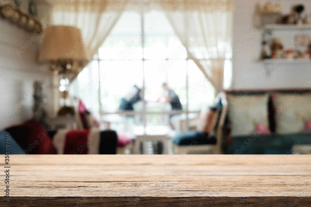 Empty wooden table space platform and blurred restaurant or coffee shop background for product display montage.