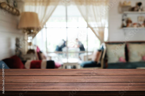 Empty wooden table space platform and blurred restaurant or coffee shop background for product display montage.