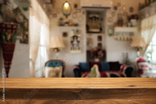 Wooden table space platform and blurred restaurant or coffee shop background for product display montage. © qOppi