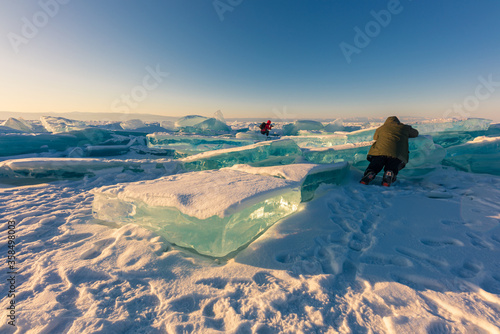 Traveler and photographer on the ice of Lake Baikal, Russia.