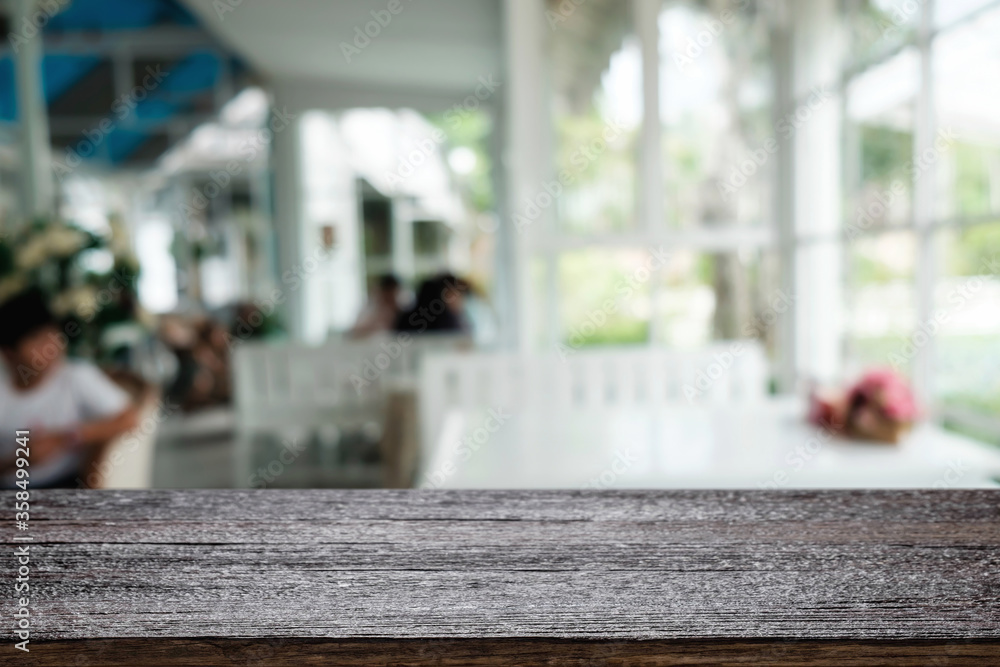 Empty wooden table space platform and blurred restaurant or coffee shop background for product display montage. Empty wooden table space platform and blurred restaurant or coffee shop background for product display montage.