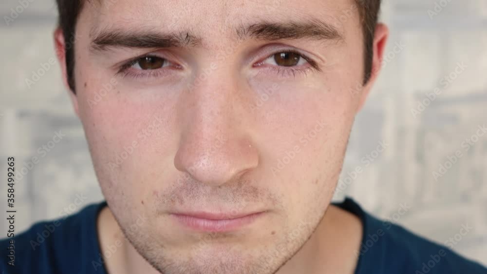 a sleepy and sloppy man looks at the camera a sleepy and sloppy man looks at the camera