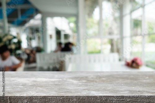 Empty wooden table space platform and blurred restaurant or coffee shop background for product display montage.