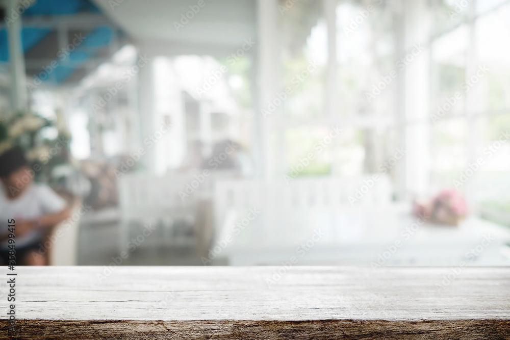 Wooden desk space platform and blurred restaurant or coffee shop background for product display montage.