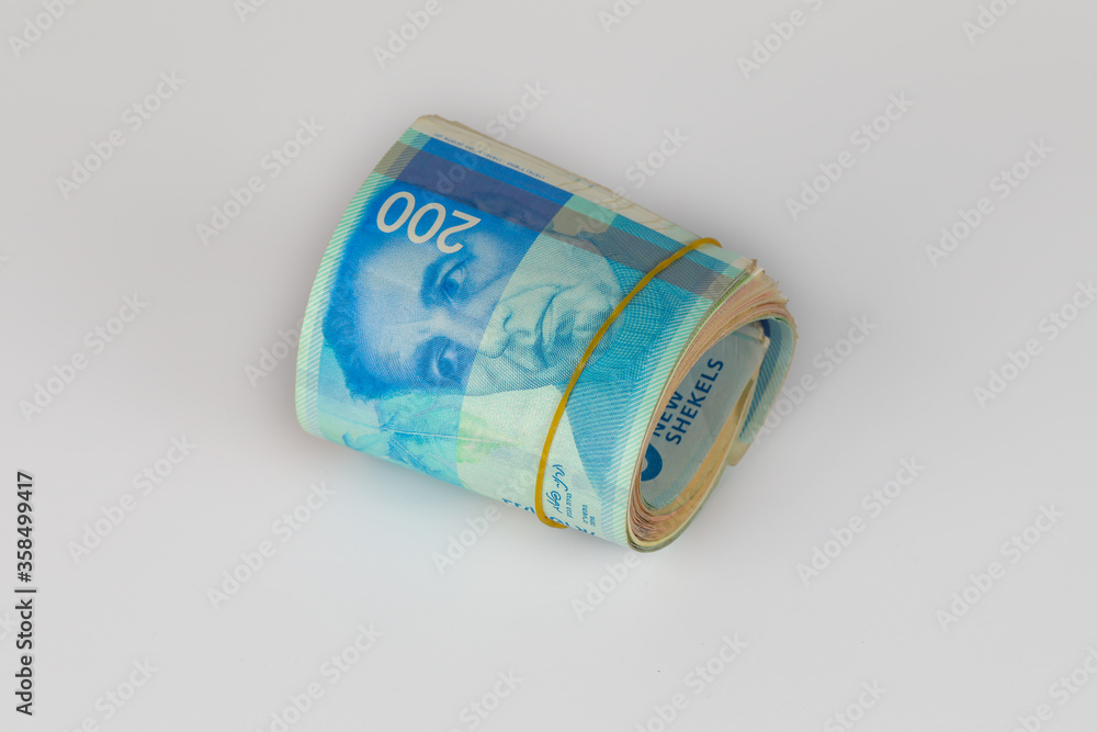 Bunch of 200 Israeli New Shekels (NIS) bills rolled together with a rubber band. Bunch of 200 Israeli New Shekels (NIS) bills rolled together with a rubber band.