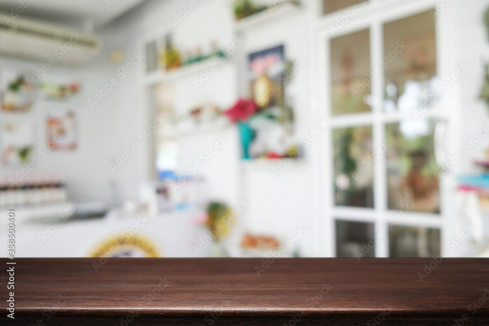 Empty wooden table space platform and blurred restaurant or coffee shop background for product display montage.