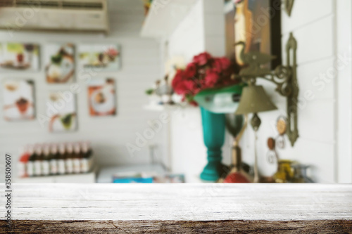 Empty wooden table space platform and blurred restaurant or coffee shop background for product display montage.