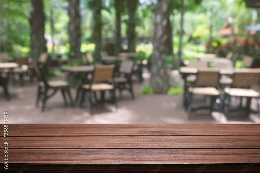 Empty wooden table space platform and blurred restaurant or coffee shop background for product display montage. Empty wooden table space platform and blurred restaurant or coffee shop background for product display montage.