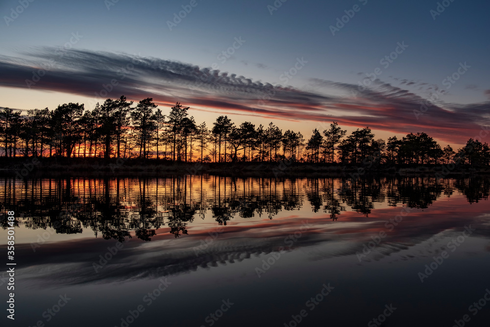 Fototapeta premium stunningly beautiful view of the evening sky over a forest lake