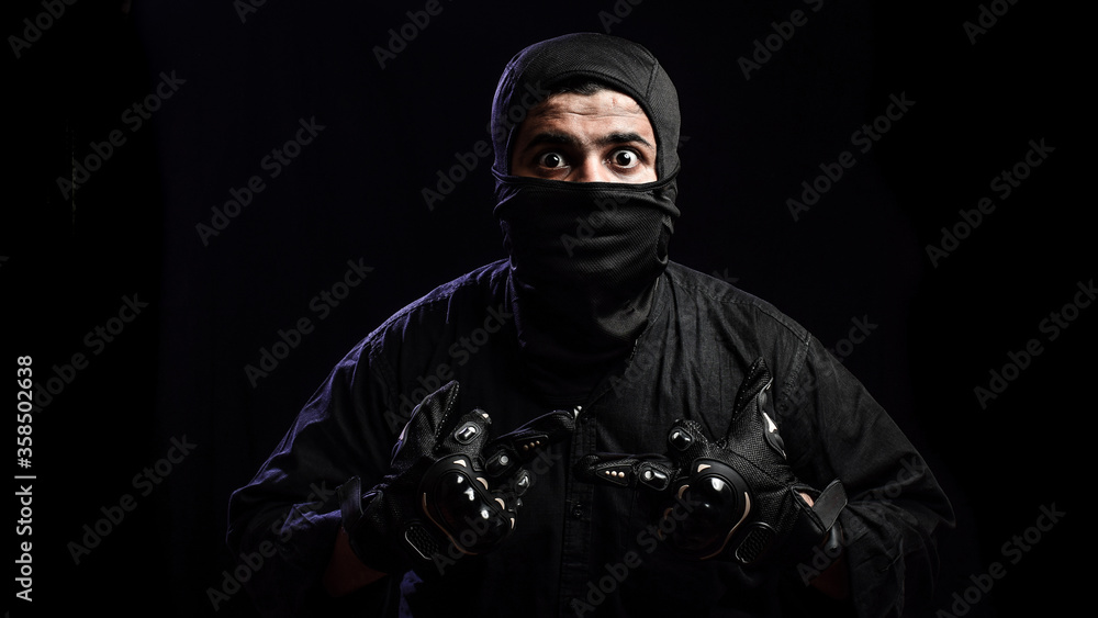 Scared man with mask fearing for corona virus pandemic. Young Man wearing protective face mask.