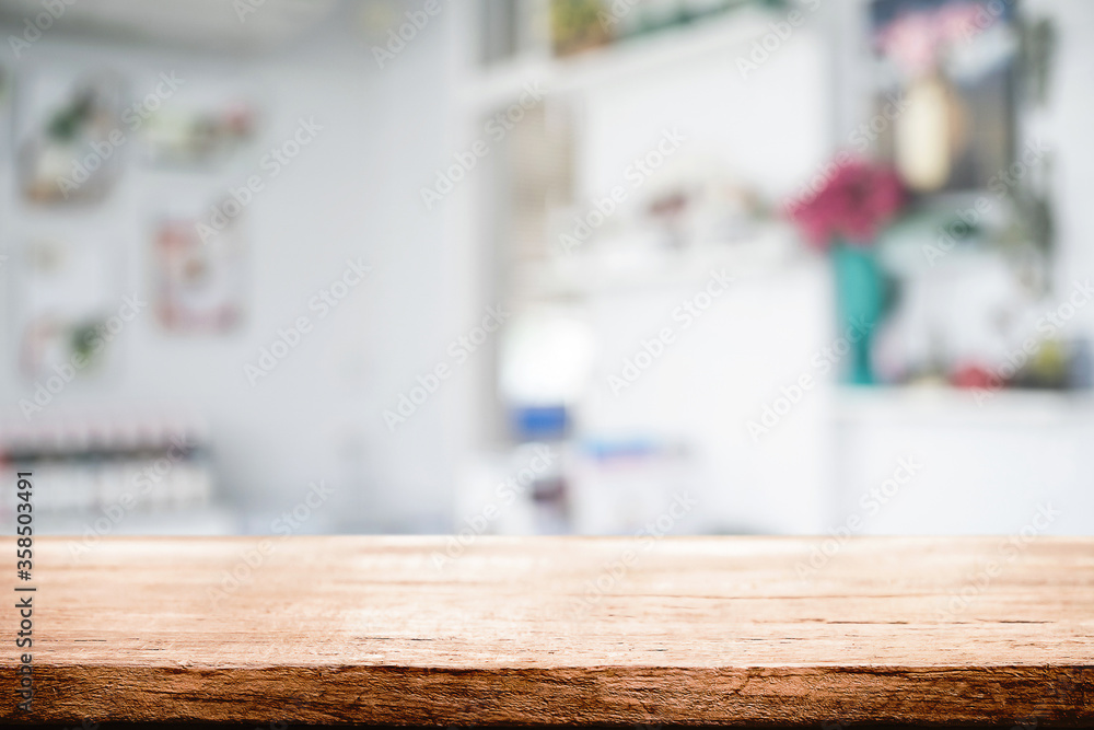 Empty wooden desk space platform over blurred restaurant or coffee shop background for product display montage. Empty wooden desk space platform over blurred restaurant or coffee shop background for product display montage.