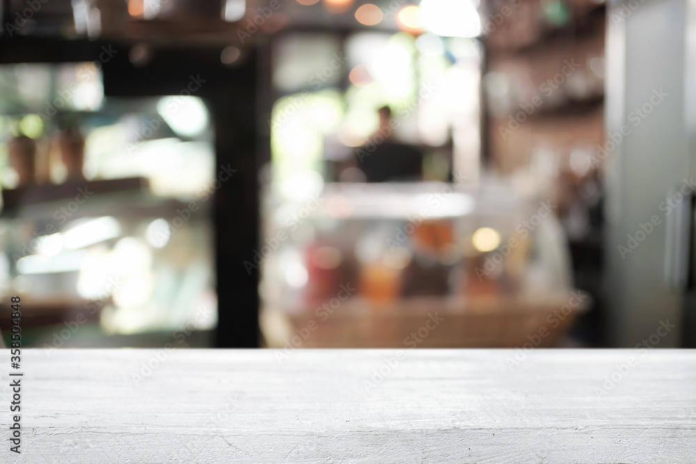 Empty wooden desk space platform over blurred restaurant or coffee shop background for product display montage. Empty wooden desk space platform over blurred restaurant or coffee shop background for product display montage.