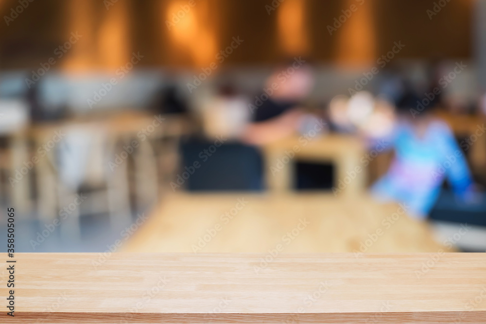 Empty wooden table space platform and blurred restaurant or coffee shop background for product display montage. Empty wooden table space platform and blurred restaurant or coffee shop background for product display montage.