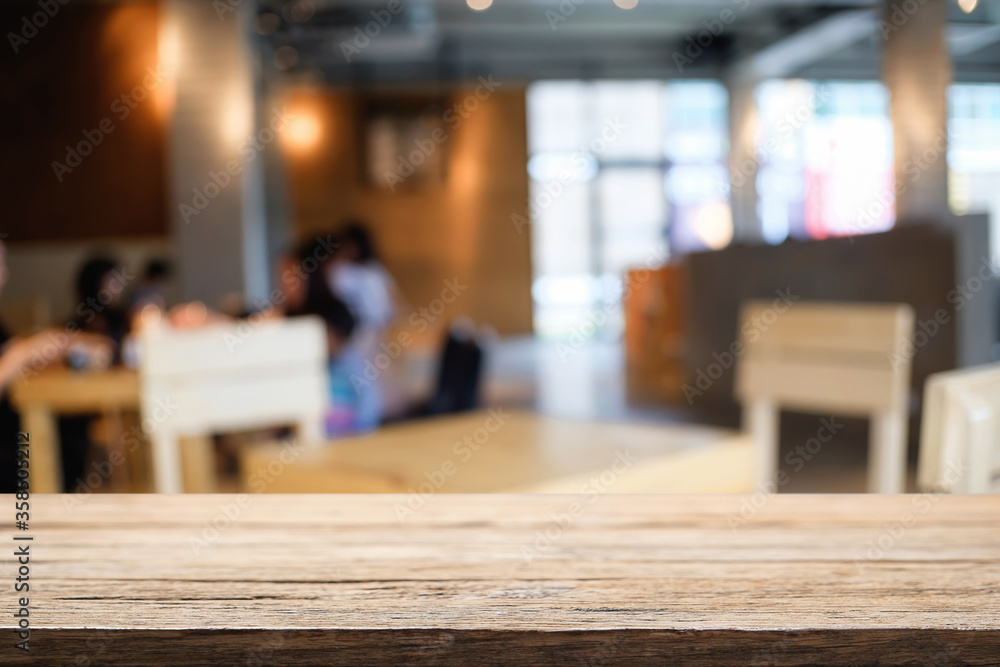 Empty wooden table space platform and blurred restaurant or coffee shop background for product display montage.