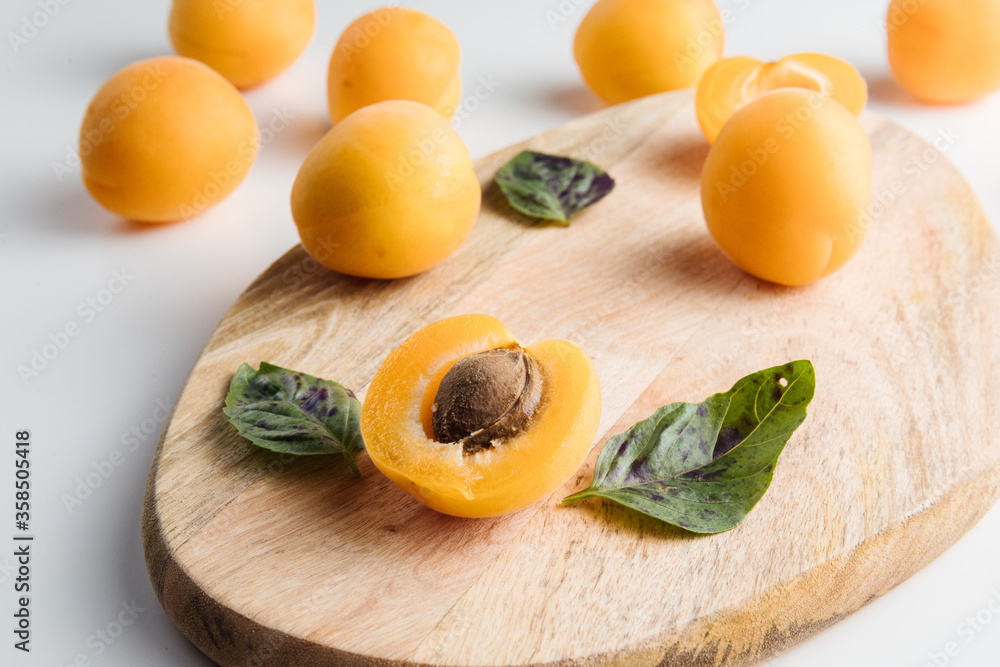 Close-up of ripe peaches on the table. Ripe peaches with leaves Close-up of ripe peaches on the table. Ripe peaches with leaves