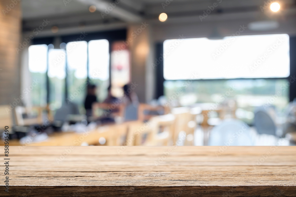 Empty wooden table space platform and blurred restaurant or coffee shop background for product display montage. Empty wooden table space platform and blurred restaurant or coffee shop background for product display montage.