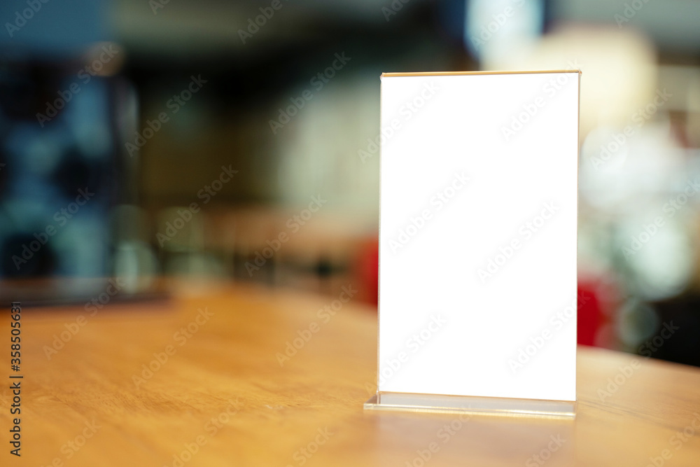 Mock up Menu frame standing on wood table in Bar restaurant cafe. space for text Mock up Menu frame standing on wood table in Bar restaurant cafe. space for text