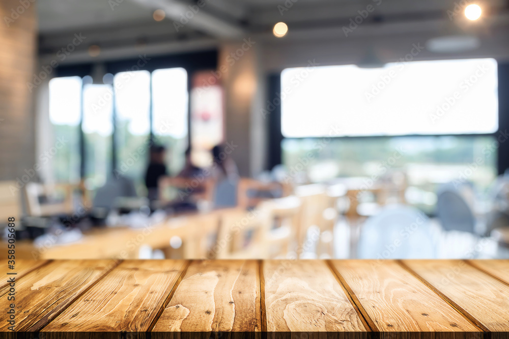 Empty wooden table space platform and blurred restaurant or coffee shop background for product display montage. Empty wooden table space platform and blurred restaurant or coffee shop background for product display montage.