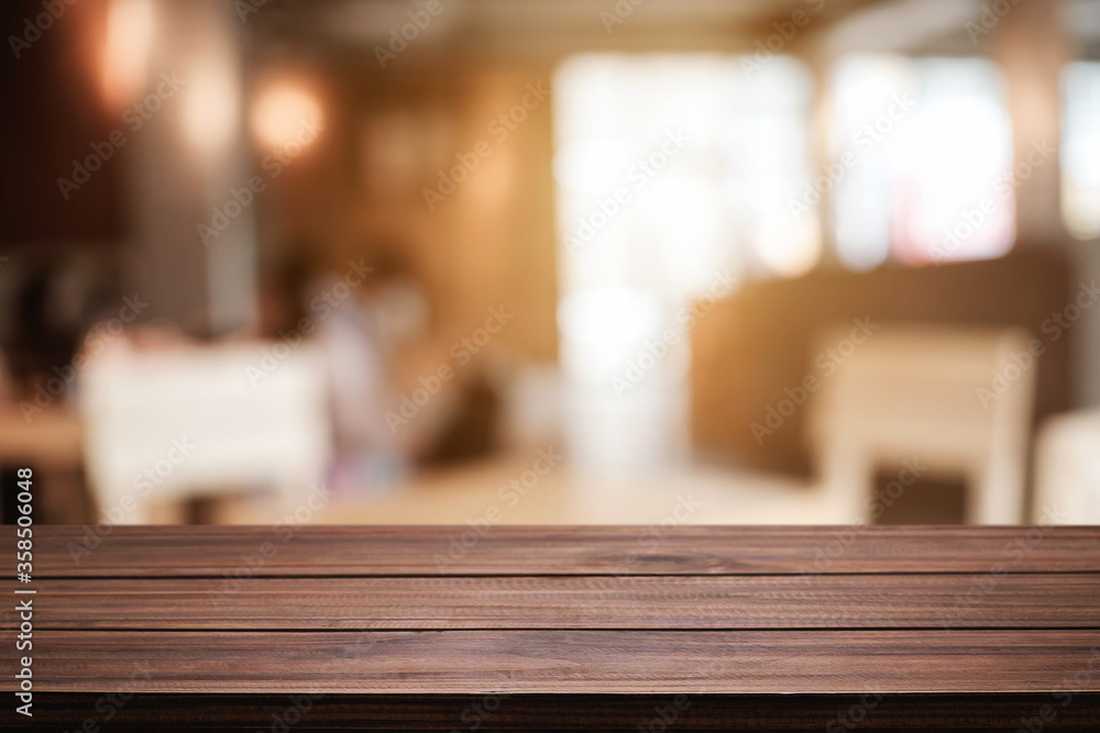 Empty wooden table space platform and blurred resturant or coffee shop background for product display montage.