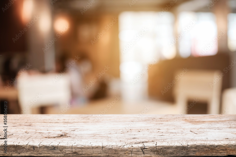 Empty wooden table space platform and blurred resturant or coffee shop background for product display montage. Empty wooden table space platform and blurred resturant or coffee shop background for product display montage.