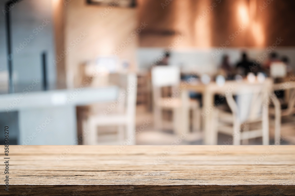 Empty wooden table space platform and blurred restaurant or coffee shop background for product display montage. Empty wooden table space platform and blurred restaurant or coffee shop background for product display montage.