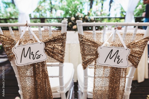 Mr & Mrs sign on chairs at wedding reception