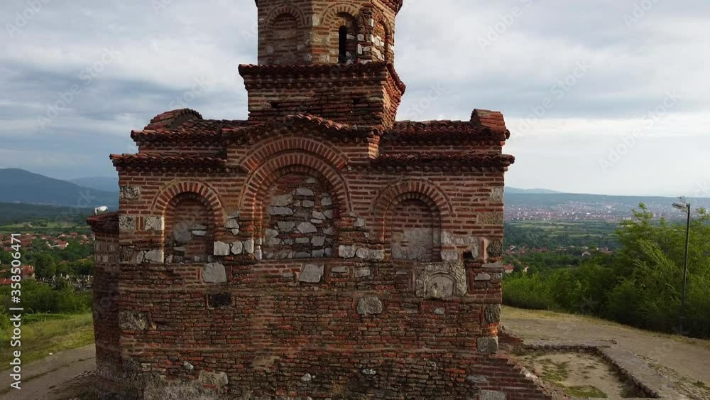 Medieval orthodox church on the top of the hill with a view to the city. Aerial view Medieval orthodox church on the top of the hill with a view to the city. Aerial view