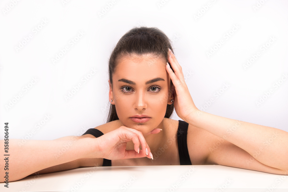 Beauty portrait of young woman with natural look, isolated on white. Nude make up, perfect skin, skin care concept Beauty portrait of young woman with natural look, isolated on white. Nude make up, perfect skin, skin care concept