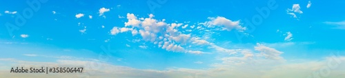 Blue sky with white clouds panoramic big shot. Background from the cloudy sky. Long and stretched clouds in the sky.Blue sky with long clouds for background.