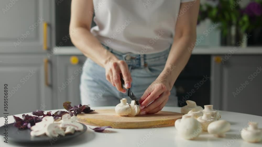 Girl cuts vegetables in a bright kitchen. Healthy food. Girl cuts vegetables in a bright kitchen. Healthy food.