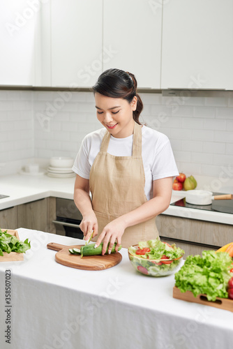 Young Woman Cooking in the kitchen. Healthy Food. Dieting Concept.