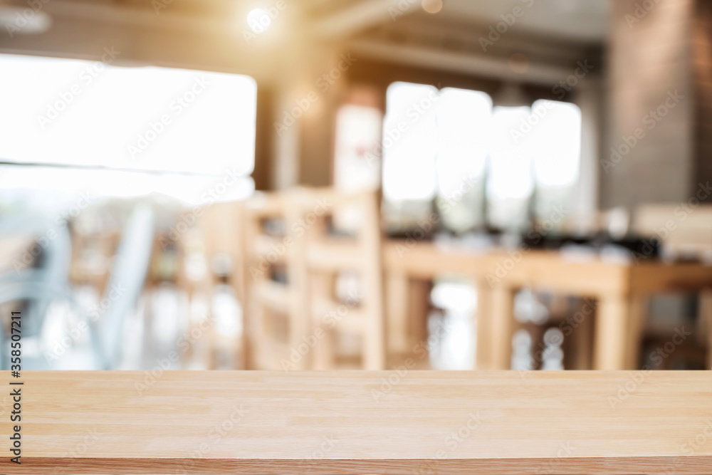 Empty wooden desk space platform with blur restaurant or coffee shop background for product display montage. Empty wooden desk space platform with blur restaurant or coffee shop background for product display montage.
