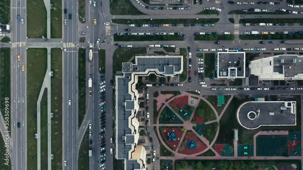 Residential complex fly over pan shot of with cars moving on the road, drone aerial shot. High quality footage zoom out of russian suburban area and cars parked near houses Residential complex fly over pan shot of with cars moving on the road, drone aerial shot. High quality footage zoom out of russian suburban area and cars parked near houses