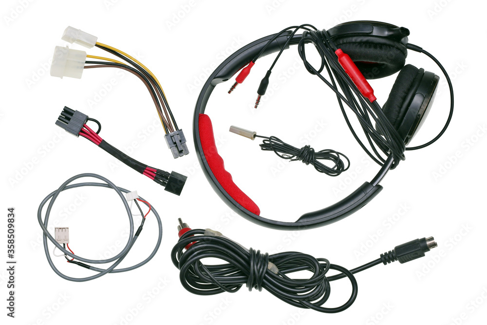Headphones and standard video audio computer wires and cables lie on the technician's table isolated Headphones and standard video audio computer wires and cables lie on the technician's table isolated