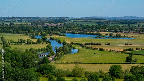 Wide angle shot of a large landscape full of trees and water in Wittenham Clumps, UK photo